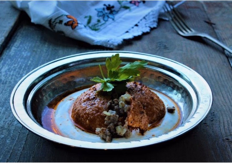 A boiled bulgur kutleh cut open to show the meat filling