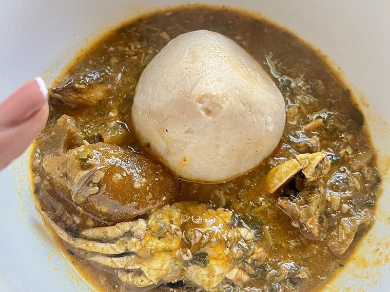 Ball of banku in okra stew with crab
