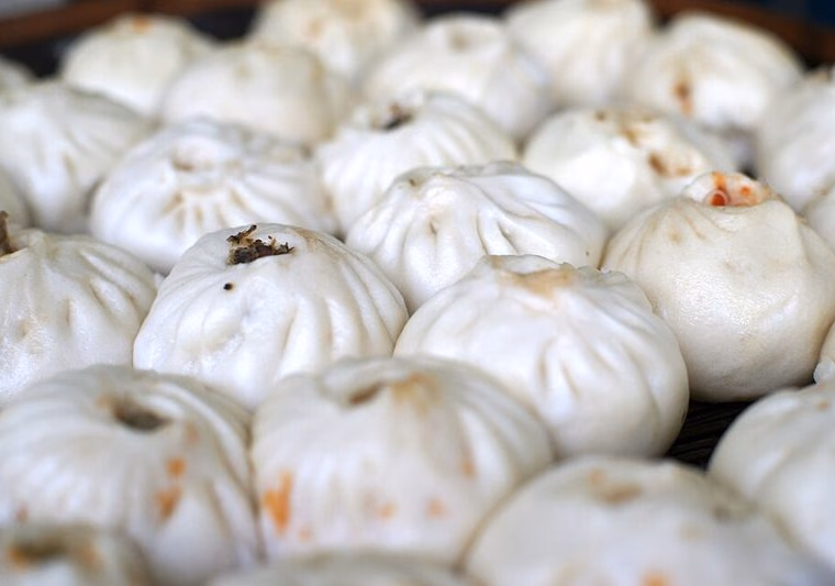 Rows of steamed baozi with pleated tops