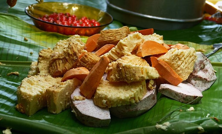 Opened bougna of yam, taro and sweet potato on banana leaves