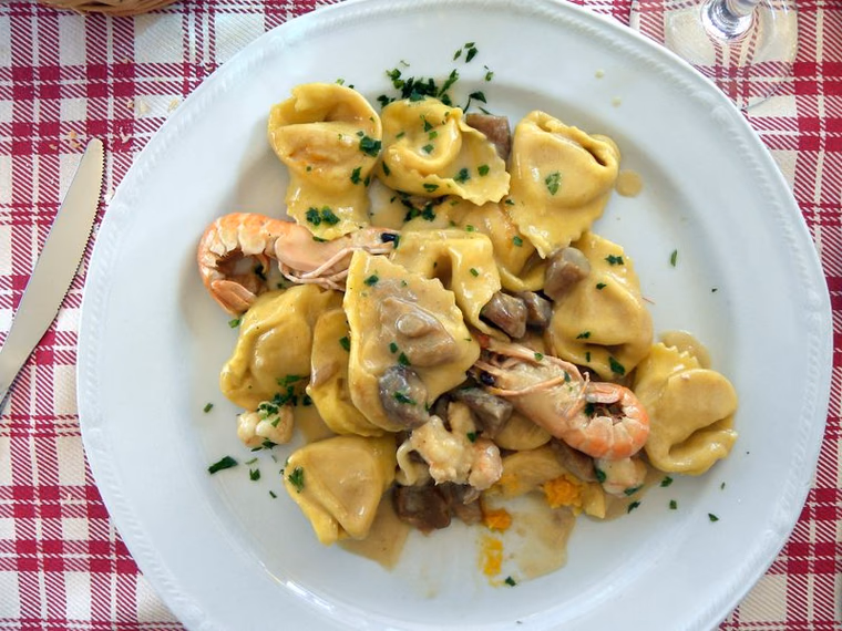Pumpkin cappellacci with scampi and porcini