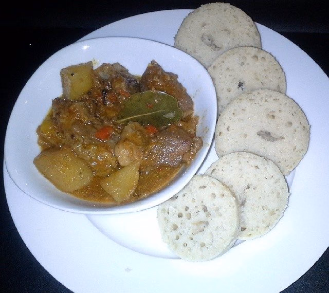 Slices of dombolo steamed bread with beef stew