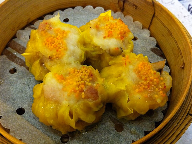 Steamed siu mai with roe in a bamboo steamer