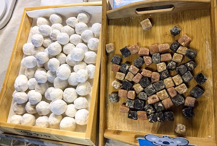Raw yuanxiao next to cubes of filling