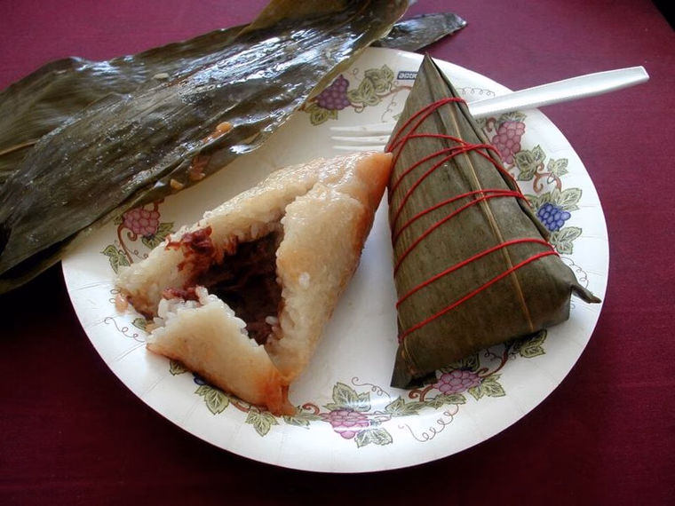 Leaf-wrapped zongzi tied with string